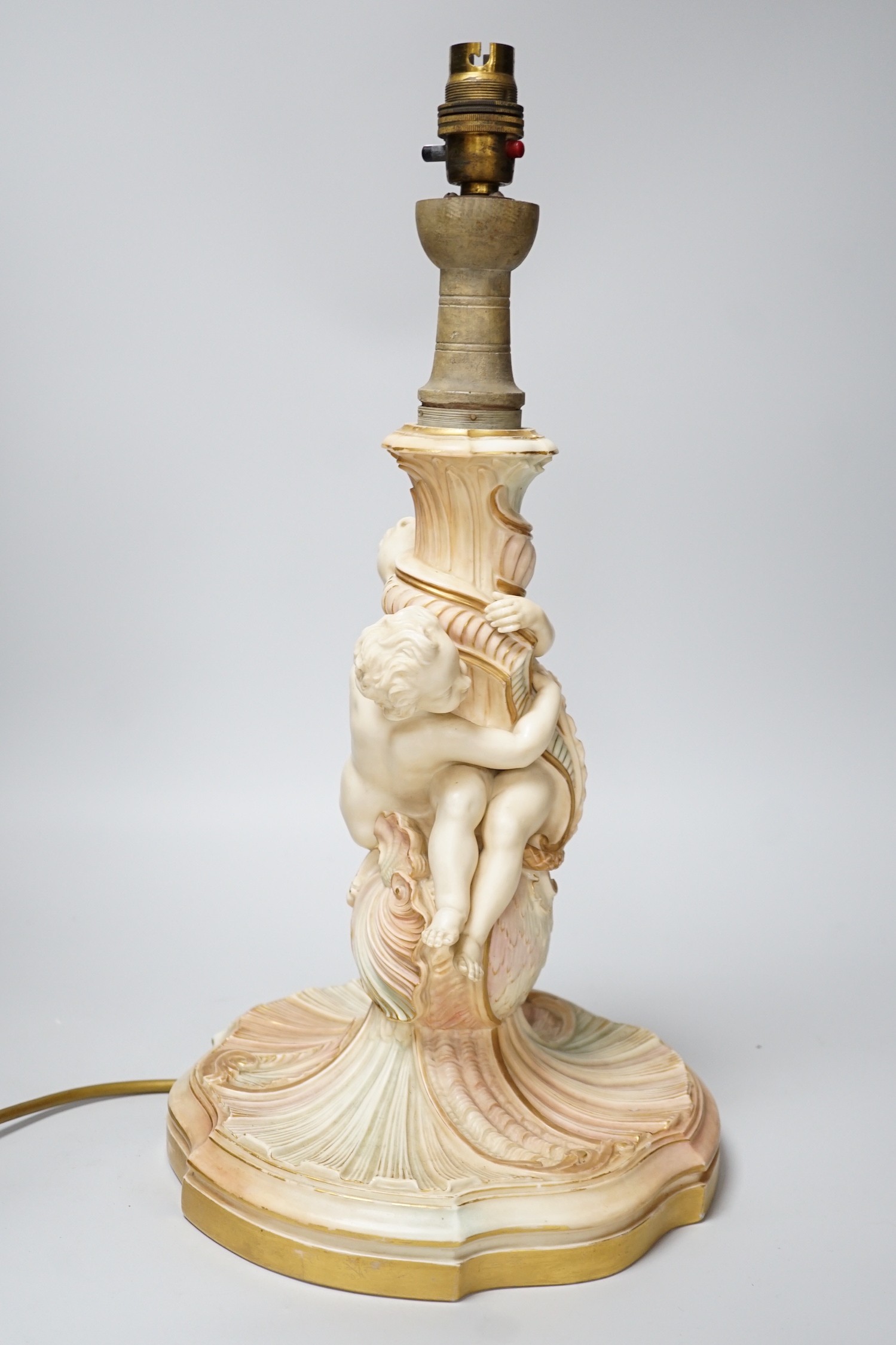 A large Royal Worcester blush ivory cherub lamp base, 40cm not including light fitting